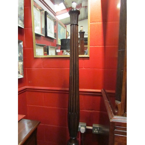 4121 - A carved mahogany standard lamp with turned and fluted column on ball in claw tripod base