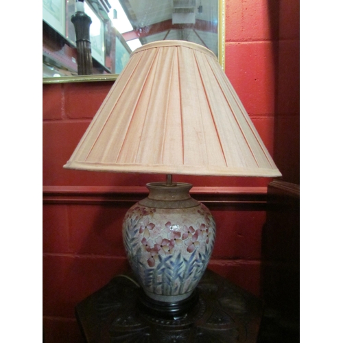 4123 - A bulbous form table lamp decorated with flowers, pleated shades