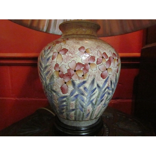 4123 - A bulbous form table lamp decorated with flowers, pleated shades