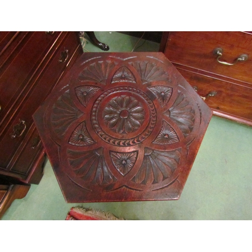 4124 - An Arts & Crafts two tier carved lamp table with Moorish design, the hexagonal top and shelf joined ... 