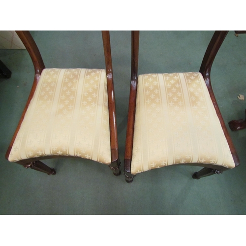 4127 - A pair of William IV mahogany chairs with carved backrest over concave front seats on turned and cha... 