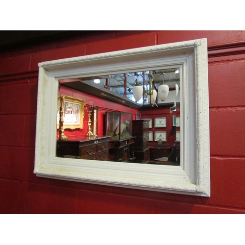 4138 - A white painted ornate framed bevel edged rectangular wall mirror, 75cm x 100cm         (R)     £50