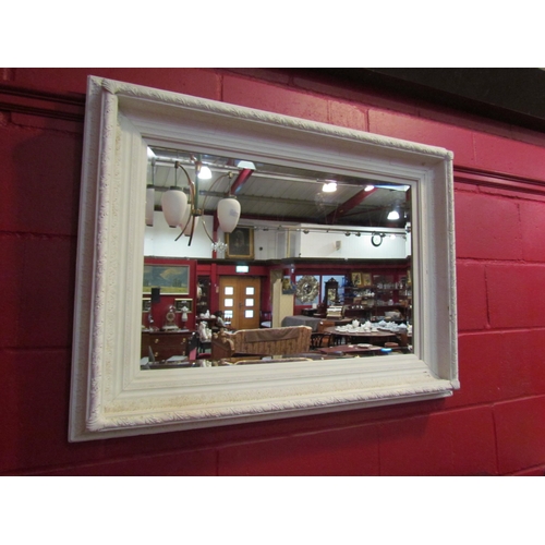 4138 - A white painted ornate framed bevel edged rectangular wall mirror, 75cm x 100cm         (R)     £50