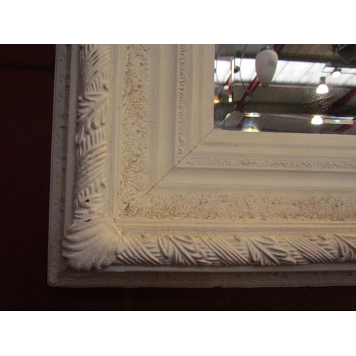 4138 - A white painted ornate framed bevel edged rectangular wall mirror, 75cm x 100cm         (R)     £50