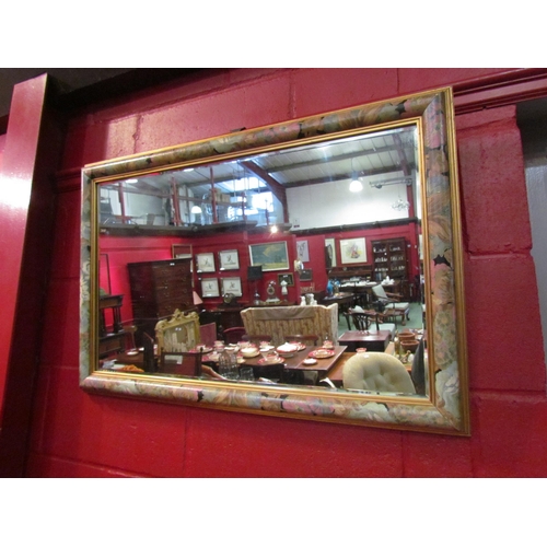 4152 - A bevel edged wall mirror with floral painted/gilt frame.  Mirror plate 45.5cm x 75.5cm         (E) ... 