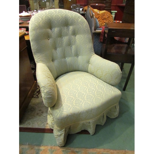 4186 - A circa 1860 button-back armchair, the scroll arms over a bow front seat on turned and tapering waln... 