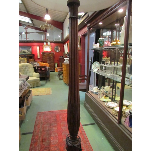 4193 - A mahogany standard lamp with carved and fluted column on a ball in claw foot tripod base