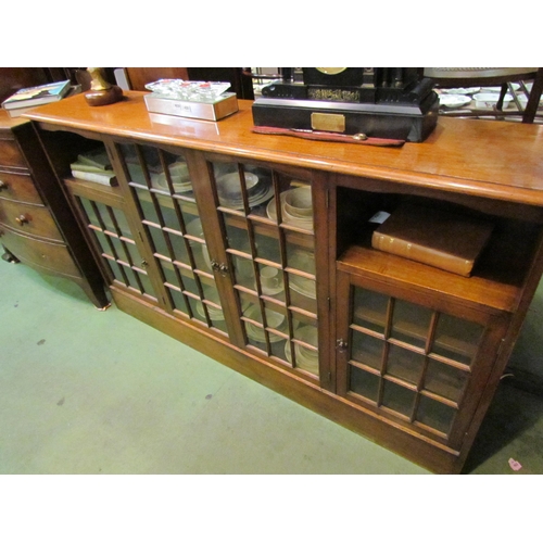 4206 - A 20th Century oak sideboard, four astragal glazed doors and two alcoves, on plinth base,  110cm tal... 