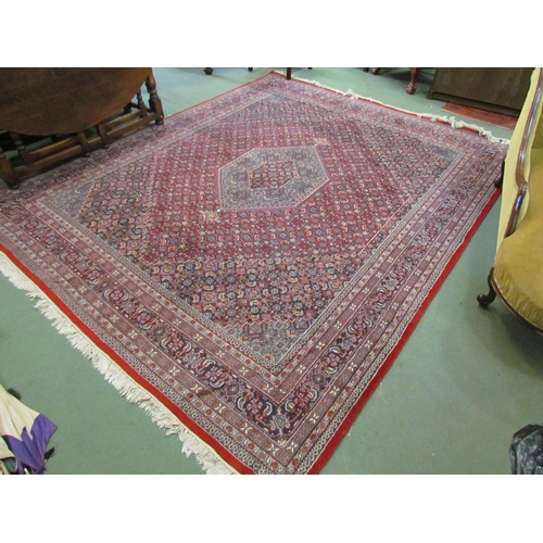 4394 - A large red ground rug with multiple boarders in navy and cream design,  310cm x 250cm