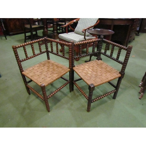 4213 - Two mahogany bobbin turned corner chairs with rush seats