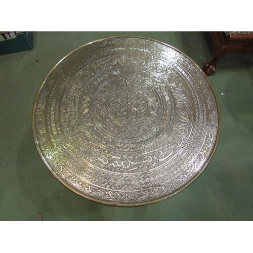 4215 - An Eastern brass top table, 59cm diameter, on campaign folding base