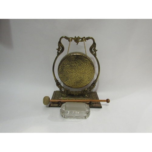 4184 - A brass table gong on stand, 28cm total height, and a cut glass letter wetter