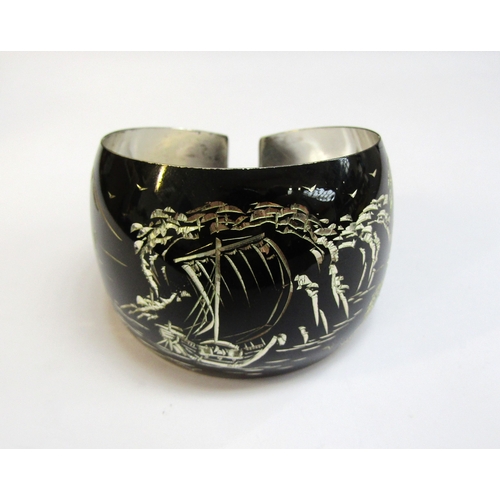 8298 - A Japanese silver bangle, the black ground with etched image of mount Fuji and a junk boat, 28.2g