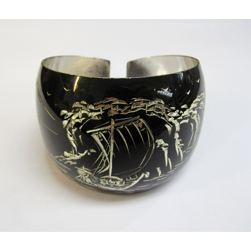 8298 - A Japanese silver bangle, the black ground with etched image of mount Fuji and a junk boat, 28.2g