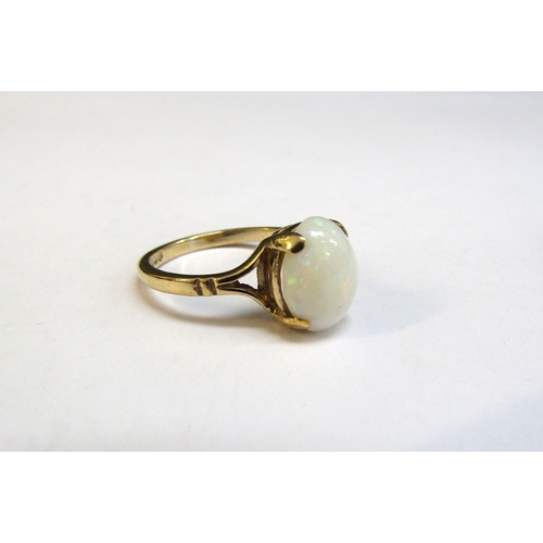 8291 - A 9ct gold ring with oval cabochon opal. Size L/M, 2.5g