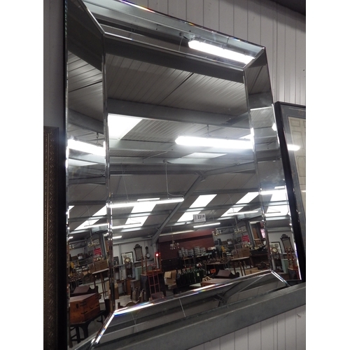 1010 - A bevelled glass wall mirror, 90cm x 70cm