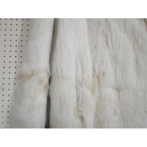 1057 - A 1930s white fur coat with a one button fastening