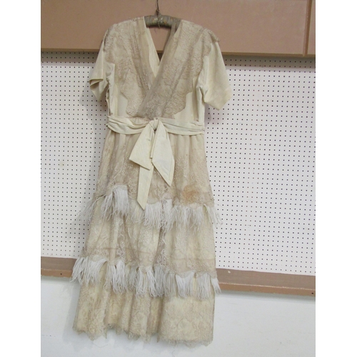 1059 - An early 20th Century cream grosgrain silk dress, possibly a wedding gown, the dress is overlaid wit... 