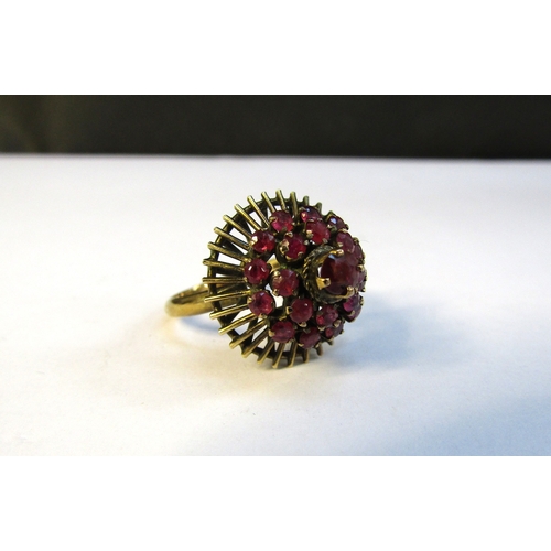 8309 - A gold ring with domed circles of rubies, stamped 14k. Size L, 3.6g   (R) £100