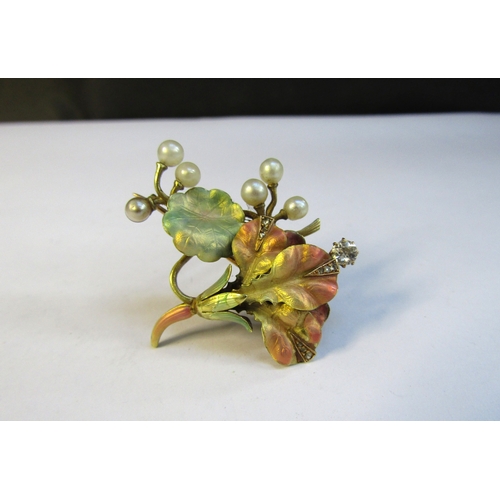 8311 - A gold brooch having leaves and flower in frosted pale enamels with pearl 