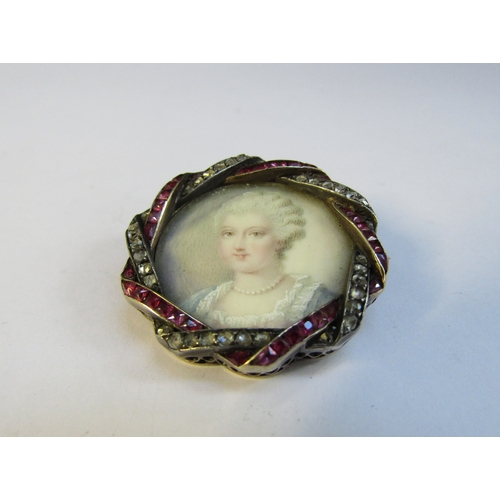 8312 - A 19th Century ruby and diamond framed miniature on ivory circular brooch depicting a female in blue... 