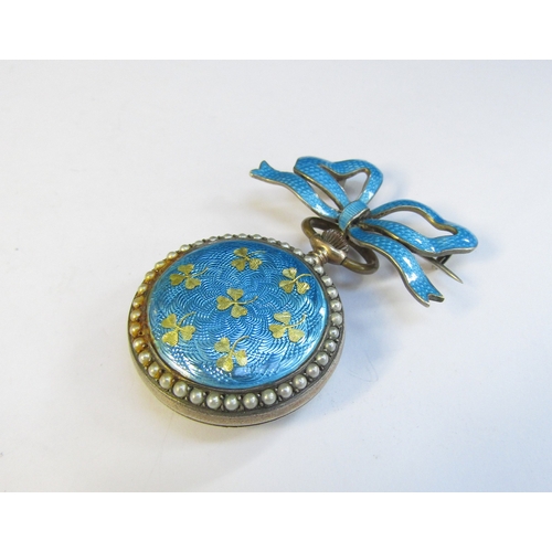 8316 - An enamel and pearl set fob watch with blue enamel bow brooch, some damage