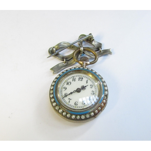 8316 - An enamel and pearl set fob watch with blue enamel bow brooch, some damage