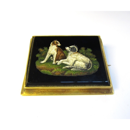 8323 - A 19th Century micro mosaic depicting two spaniels set within a rectangular black onyx panel, gilt m... 