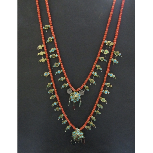 8324 - An 18th Century Eastern neckpiece, the two strands of coral beads interspersed with thin gold covere... 