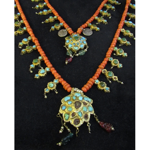 8324 - An 18th Century Eastern neckpiece, the two strands of coral beads interspersed with thin gold covere... 