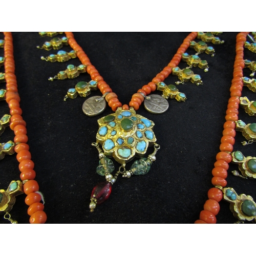 8324 - An 18th Century Eastern neckpiece, the two strands of coral beads interspersed with thin gold covere... 