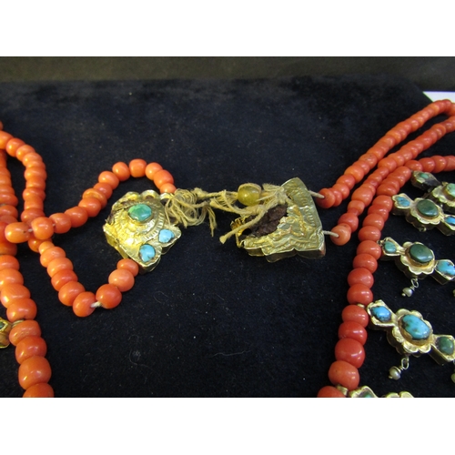 8324 - An 18th Century Eastern neckpiece, the two strands of coral beads interspersed with thin gold covere... 