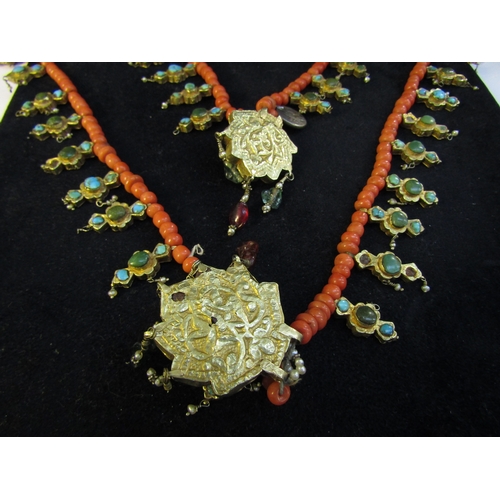 8324 - An 18th Century Eastern neckpiece, the two strands of coral beads interspersed with thin gold covere... 