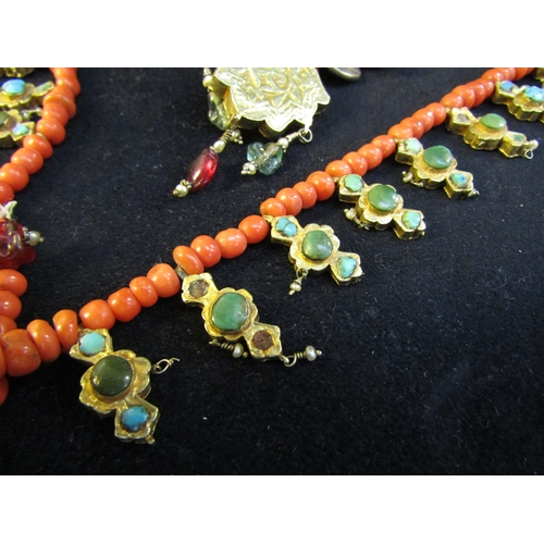 8324 - An 18th Century Eastern neckpiece, the two strands of coral beads interspersed with thin gold covere... 