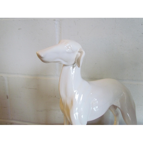 1018 - A white ceramic figure of a greyhound, 32.5cm tall