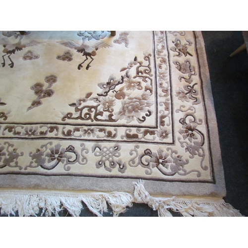 1025 - A Chinese rug, brown and beige ground with floral and crane detail, tasselled ends, 278cm x 185cm