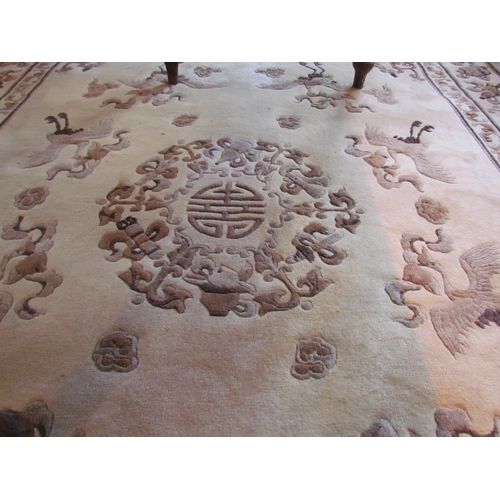 1025 - A Chinese rug, brown and beige ground with floral and crane detail, tasselled ends, 278cm x 185cm