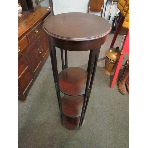 1048 - An early 20th Century mahogany four tier circular jardiniere stand with pierced supports, 116cm tall