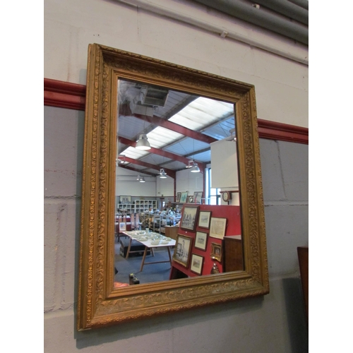 1049 - A gilt framed rectangular wall mirror, 63cm x 49.5cm