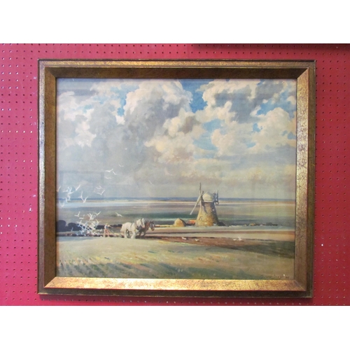 1133 - An Edward Seago print of farmer and work horses ploughing a field by windmill, gilt framed and glaze... 