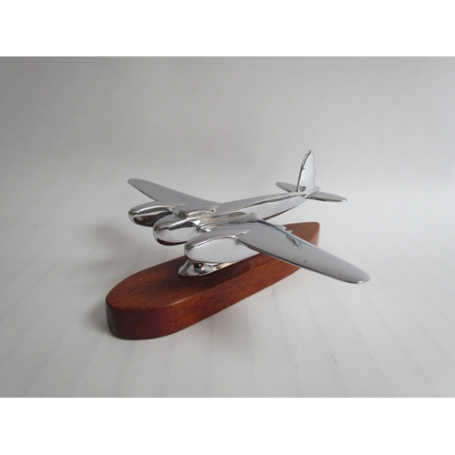 9215 - A chromed mascot of a WWII Mosquito mounted on a wooden plinth