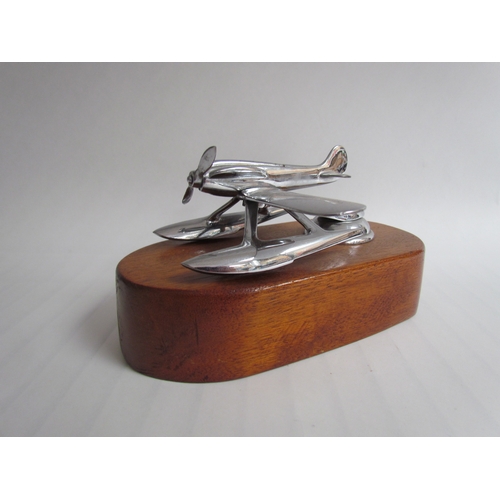 9216 - A chromed mascot of a float plane mounted on a timber plinth