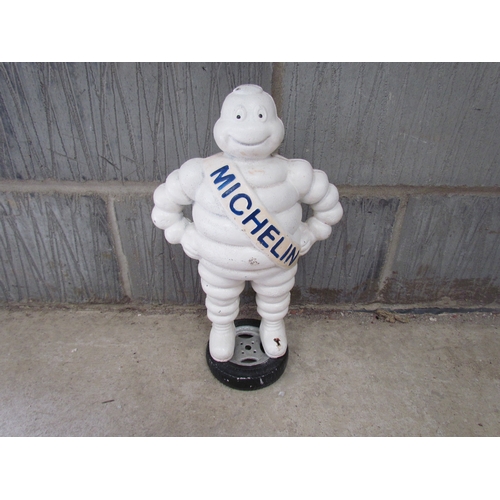 9252 - A reproduction cast Michelin Man standing on a wheel, 40cm tall