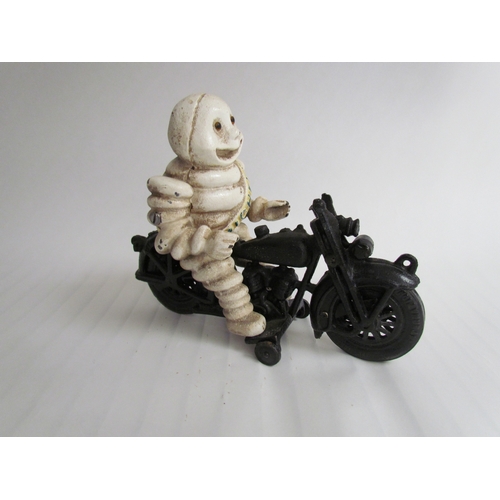 9254 - A reproduction cast Michelin Man riding a motorcycle - missing handle bars