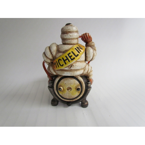 9261 - A cast reproduction Michelin Man sitting on a compressor