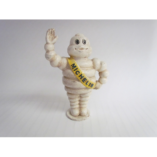 9262 - A reproduction cast waving Michelin Man, 22cm tall