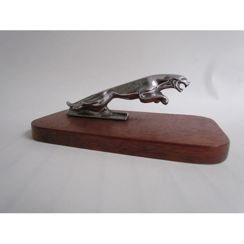 9277 - A chromed leaping Jaguar mascot mounted on a wooden plinth