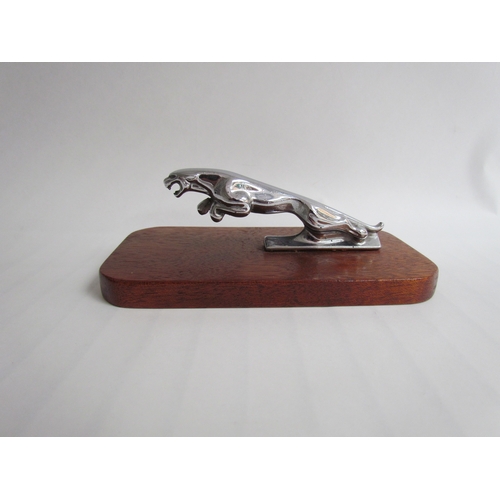 9277 - A chromed leaping Jaguar mascot mounted on a wooden plinth