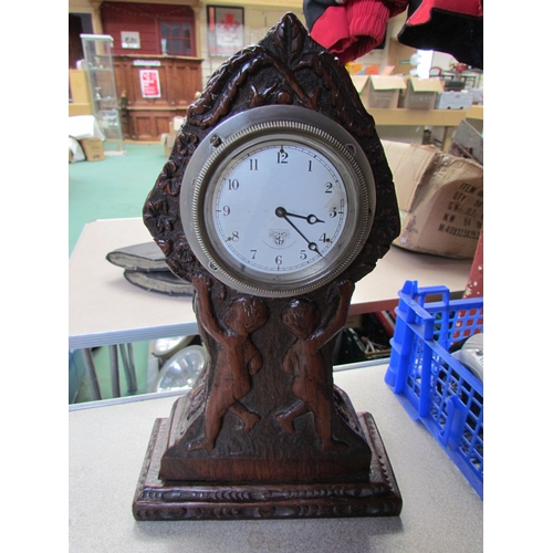 9294 - A Smiths dash clock mouted in carved wooden surround          (C)