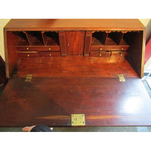 1003 - A George III mahogany bureau, drop-flap with fitted interior including secret column drawers, two sh... 